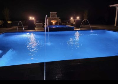 hollis new hampshire pool in backyard at night